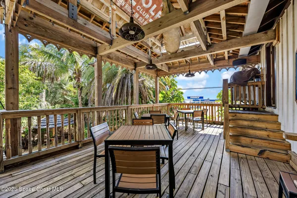 a view of a chairs and table in the balcony