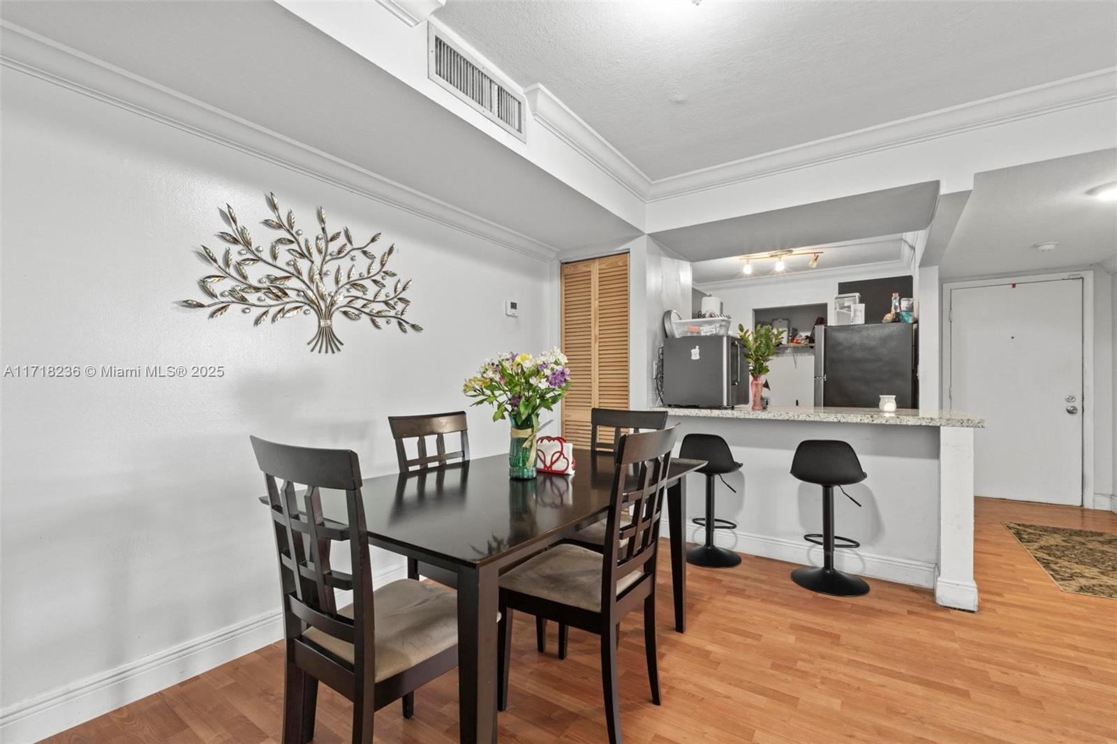 10755 Southwest 108th Avenue, Unit 301 Miami, FL 33176 - Photo 13 of 23 a view of a dining room with furniture and wooden floor
