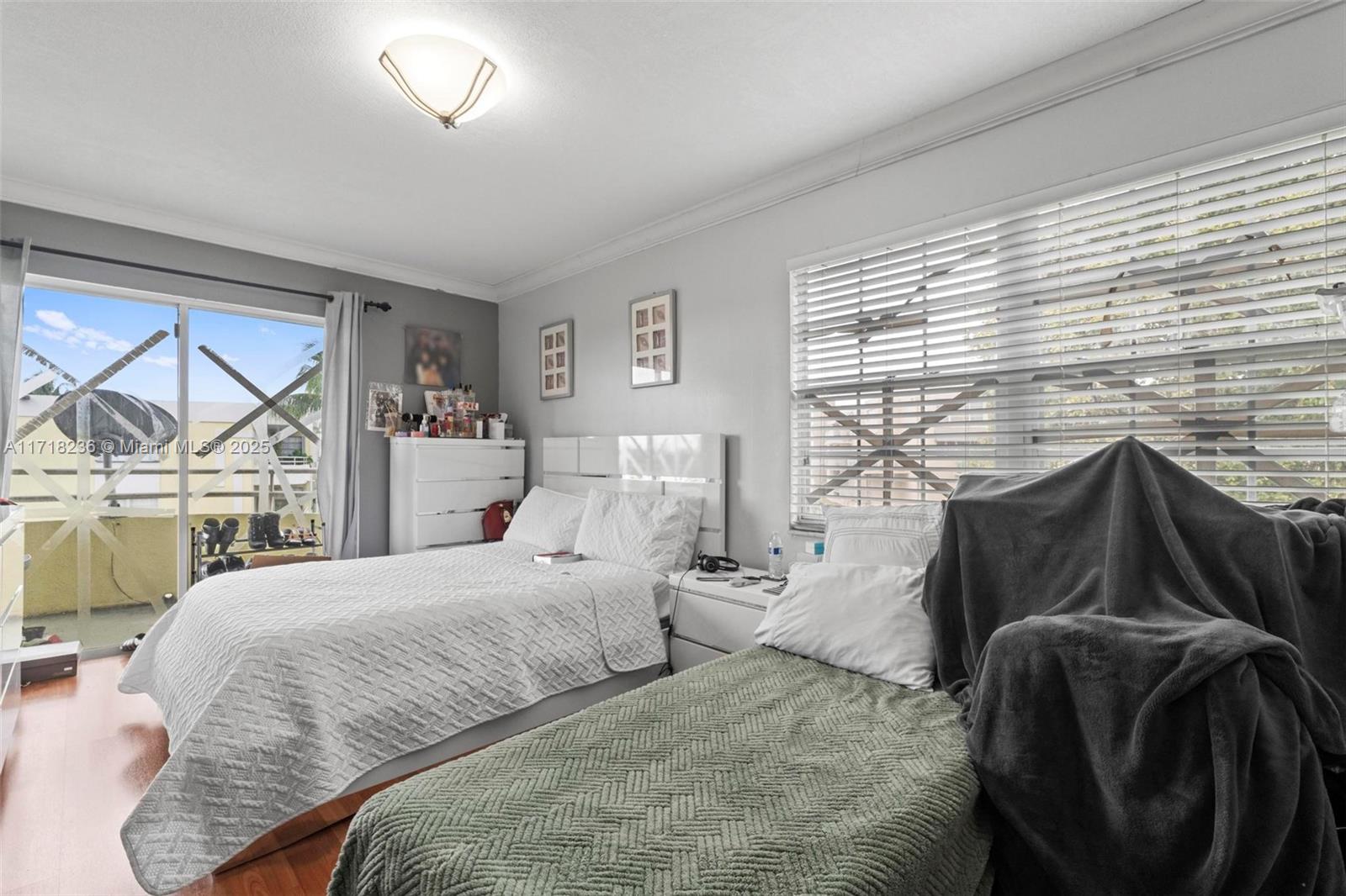 10755 Southwest 108th Avenue, Unit 301 Miami, FL 33176 - Photo 14 of 23 a bedroom with two beds and a large window