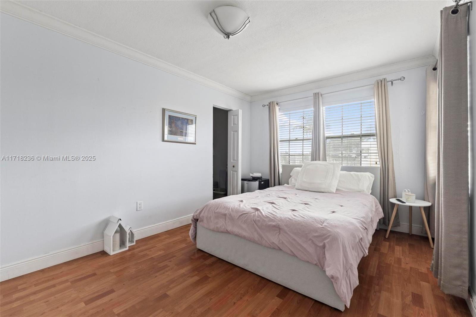 10755 Southwest 108th Avenue, Unit 301 Miami, FL 33176 - Photo 17 of 23 a bedroom with a bed and wooden floor