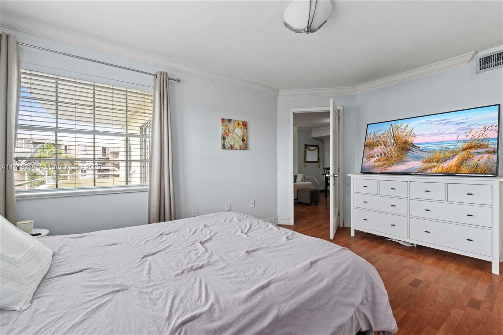 10755 Southwest 108th Avenue, Unit 301 Miami, FL 33176 - Photo 18 of 23 a bedroom with a bed and wooden floor