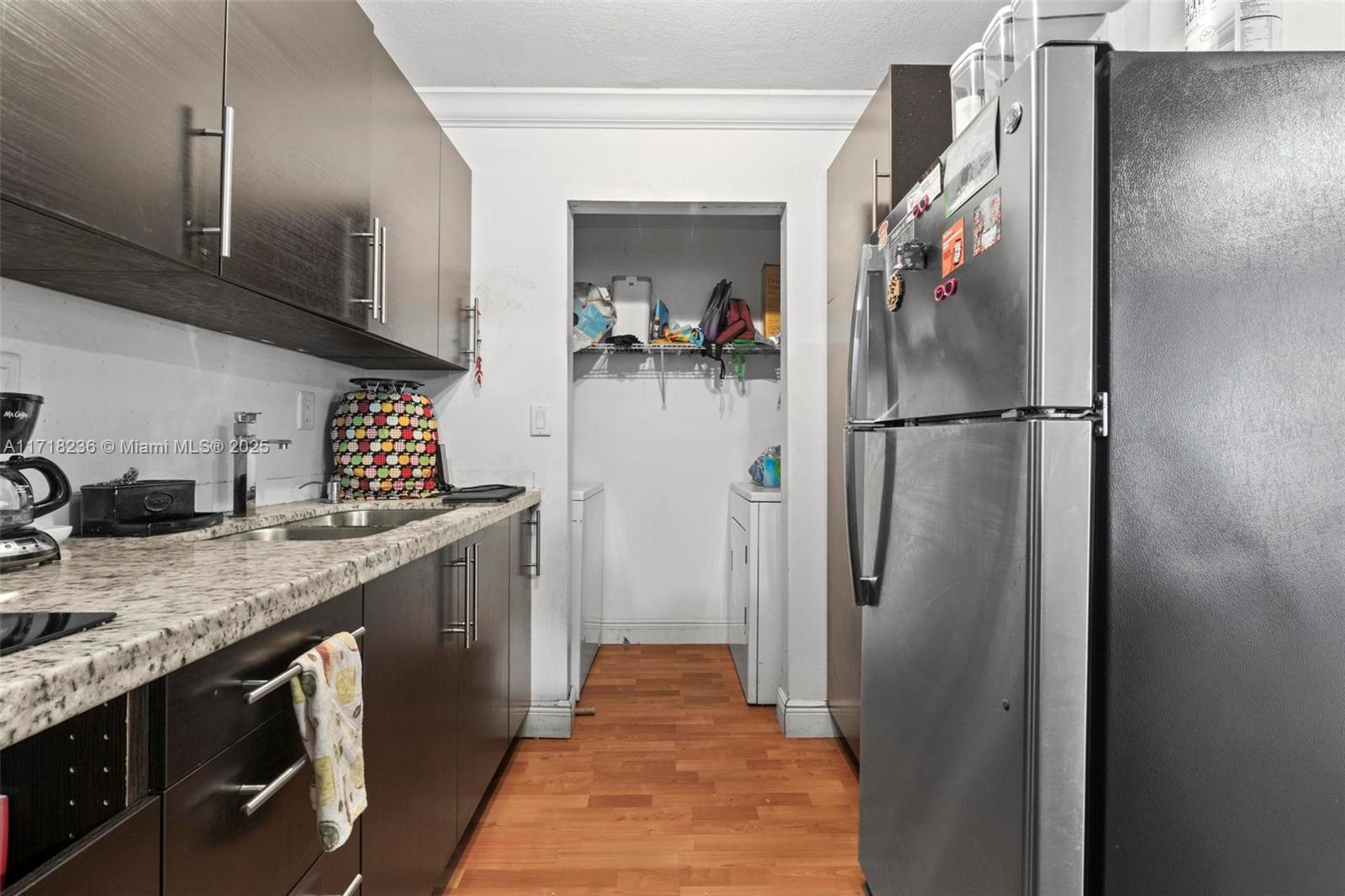 10755 Southwest 108th Avenue, Unit 301 Miami, FL 33176 - Photo 6 of 23 a kitchen with stainless steel appliances granite countertop a refrigerator and a sink