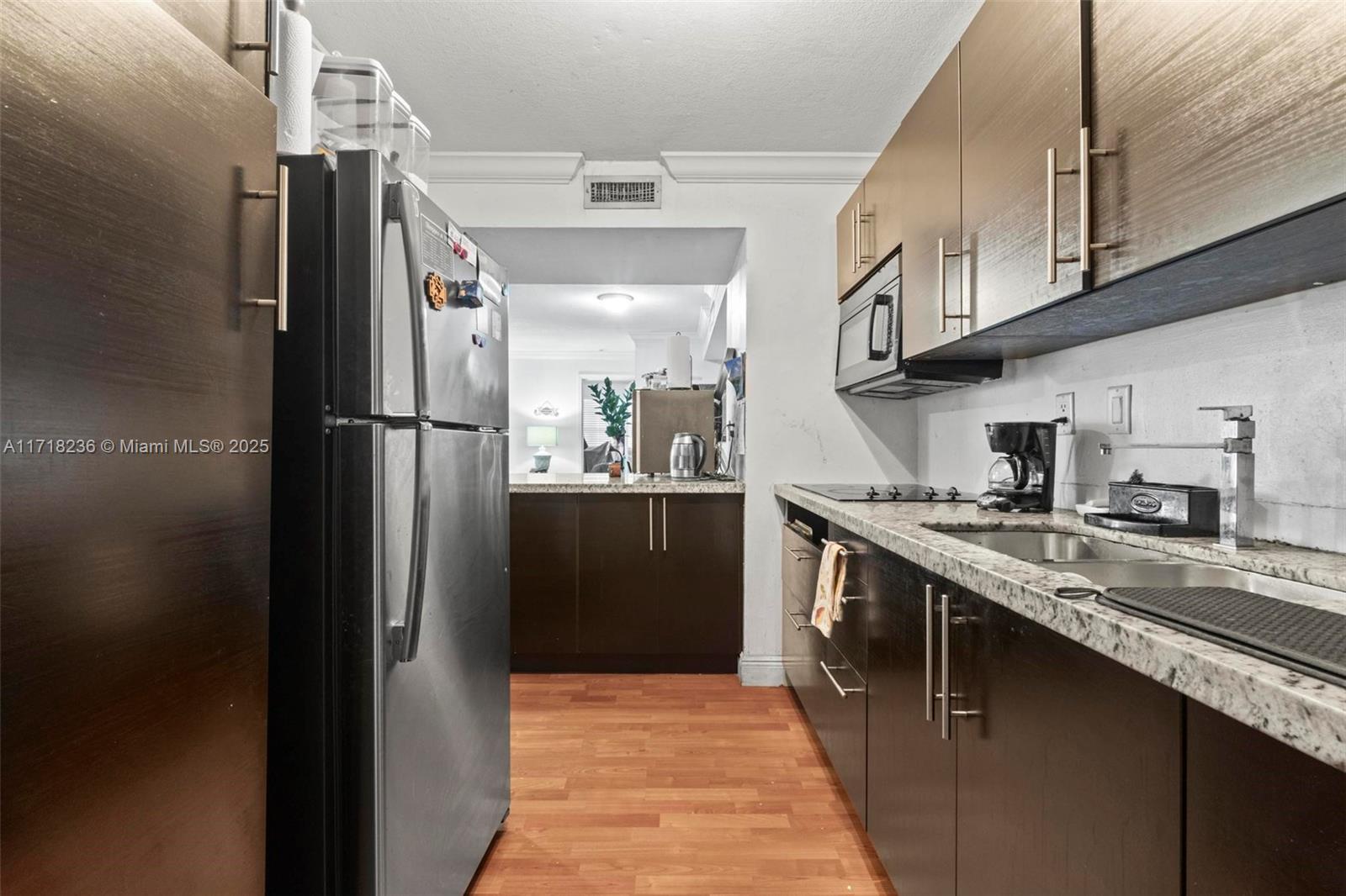10755 Southwest 108th Avenue, Unit 301 Miami, FL 33176 - Photo 7 of 23 a kitchen with stainless steel appliances granite countertop a refrigerator a stove and a sink