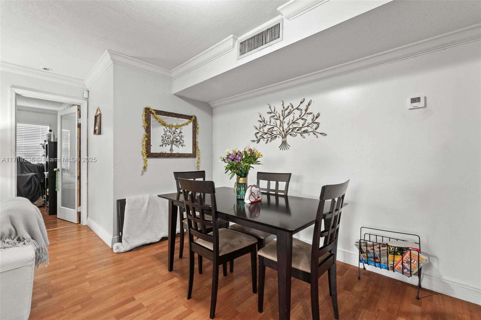 10755 Southwest 108th Avenue, Unit 301 Miami, FL 33176 - Photo 10 of 23 a view of a dining room with furniture and wooden floor