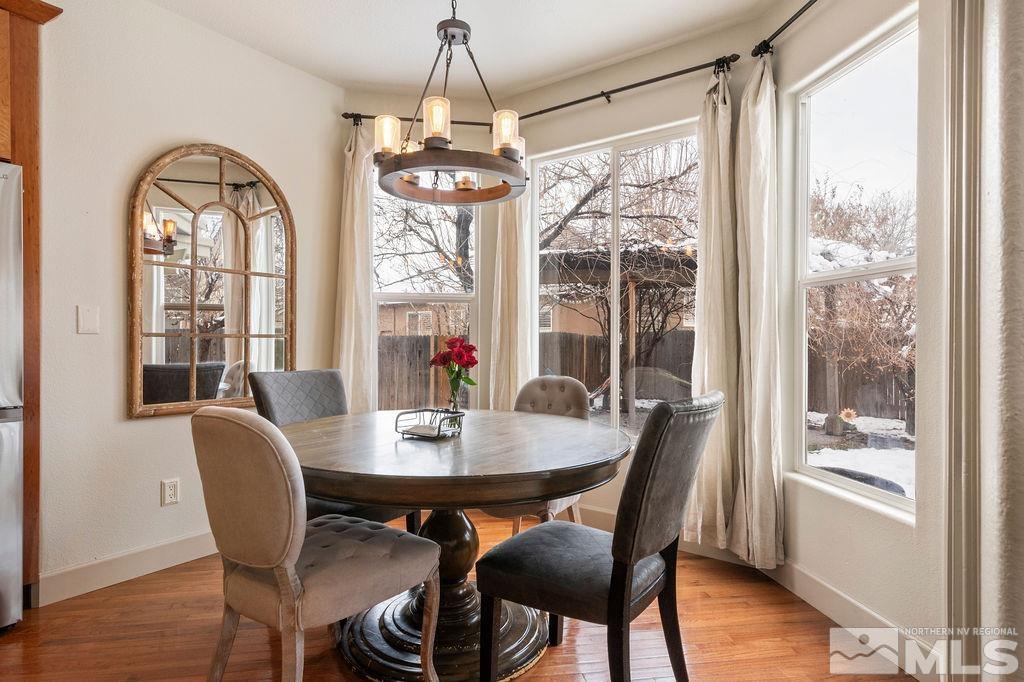9985 Moccasin Court Reno, NV 89521 - Photo 13 of 40 a view of a dining room with furniture window and wooden floor
