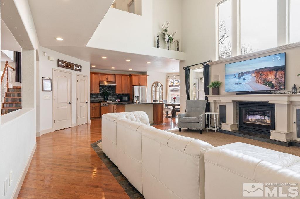 9985 Moccasin Court Reno, NV 89521 - Photo 17 of 40 a living room with furniture a fireplace and kitchen view