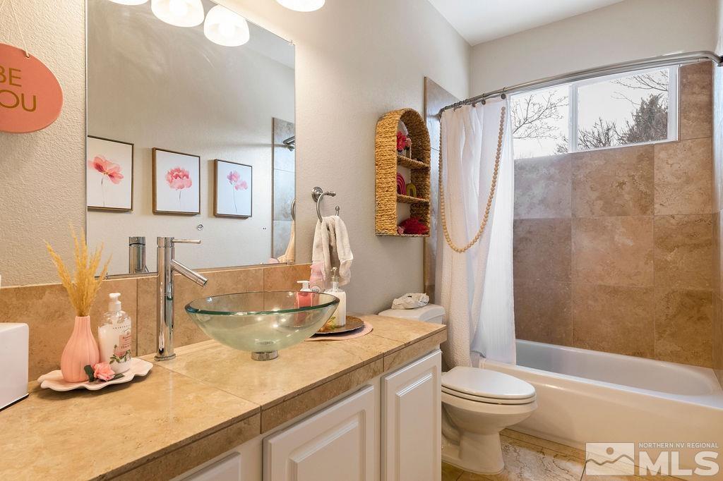 9985 Moccasin Court Reno, NV 89521 - Photo 21 of 40 a bathroom with a double vanity sink toilet and shower