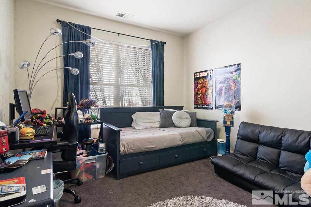 9985 Moccasin Court Reno, NV 89521 - Photo 23 of 40 a bedroom with furniture and a window