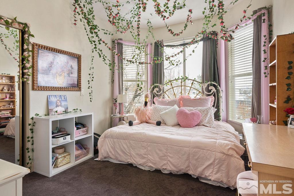 9985 Moccasin Court Reno, NV 89521 - Photo 26 of 40 a bedroom with a large bed and a window