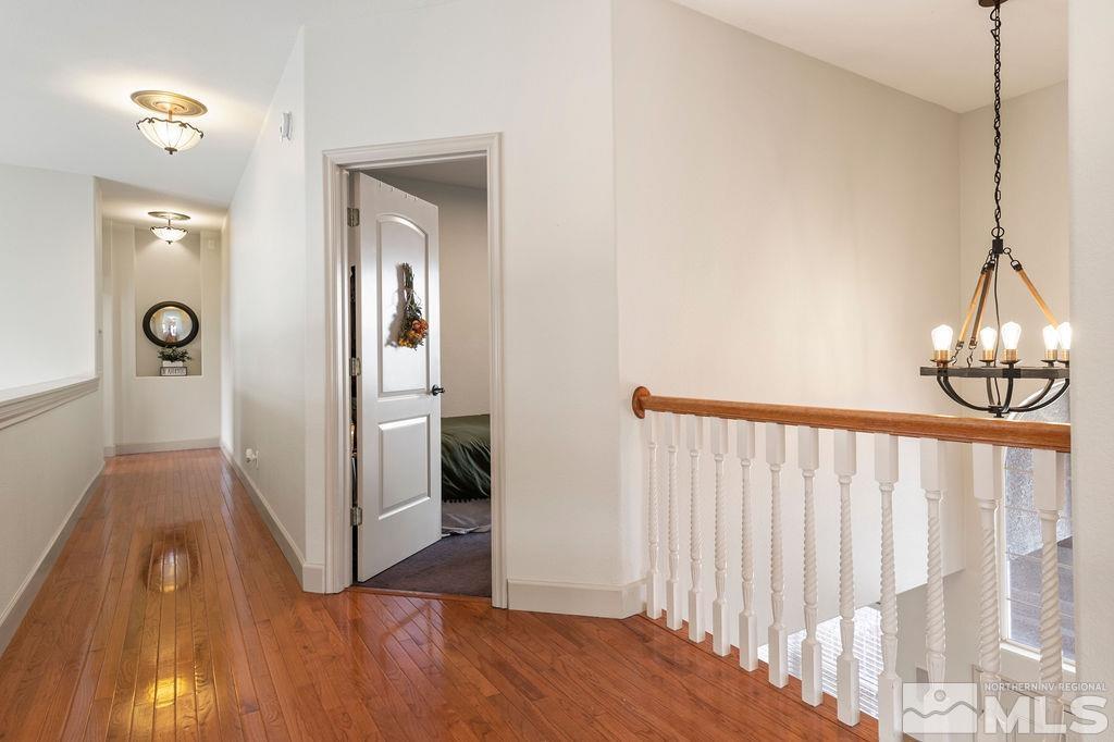 9985 Moccasin Court Reno, NV 89521 - Photo 28 of 40 a view of a hallway with wooden floor and staircase