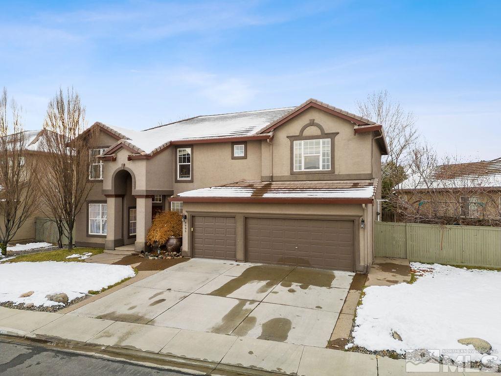 9985 Moccasin Court Reno, NV 89521 - Photo 3 of 40 a front view of a house with a yard