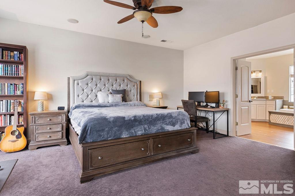 9985 Moccasin Court Reno, NV 89521 - Photo 31 of 40 a spacious bedroom with a bed and a table