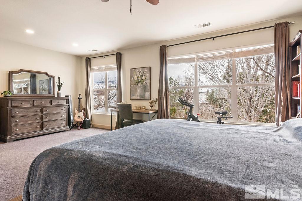 9985 Moccasin Court Reno, NV 89521 - Photo 32 of 40 a spacious bedroom with a bed and a large window