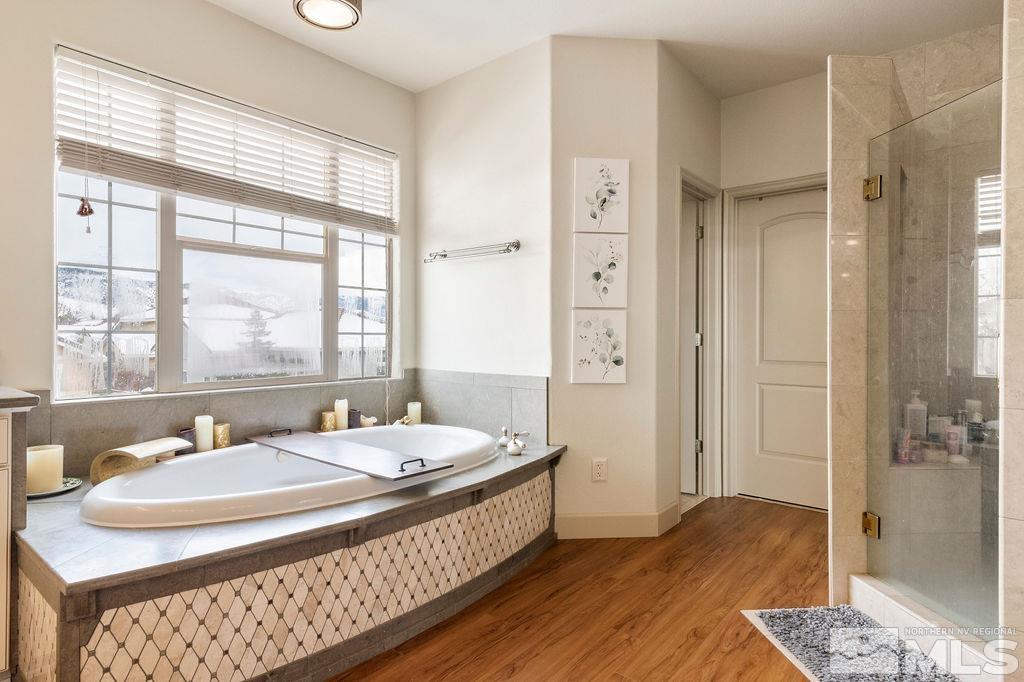 9985 Moccasin Court Reno, NV 89521 - Photo 35 of 40 a spacious bathroom with a double vanity sink a mirror and a shower