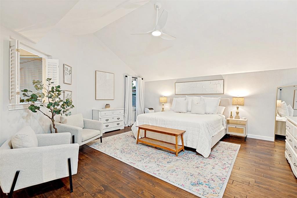3642 Word Street Dallas, TX 75204 - Photo 21 of 29 a spacious bedroom with a bed a couch and potted plant