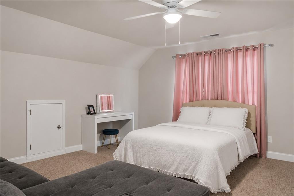 171 Strickland Loop Forsyth, GA 31029 - Photo 17 of 25 a bedroom with a bed and a chandelier