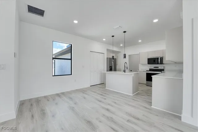 a view of kitchen with refrigerator sink and microwave