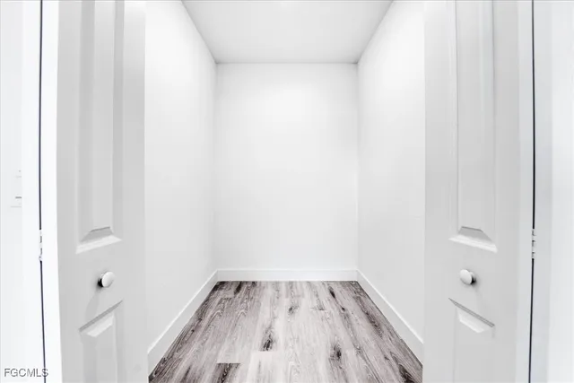 a view of a room with wooden floor and small space