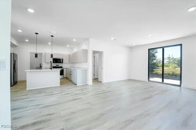 a view of kitchen with stainless steel appliances refrigerator microwave and stove