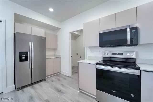 a kitchen with a stove and a microwave