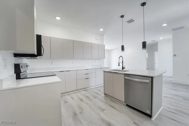 a kitchen with a sink stove and refrigerator