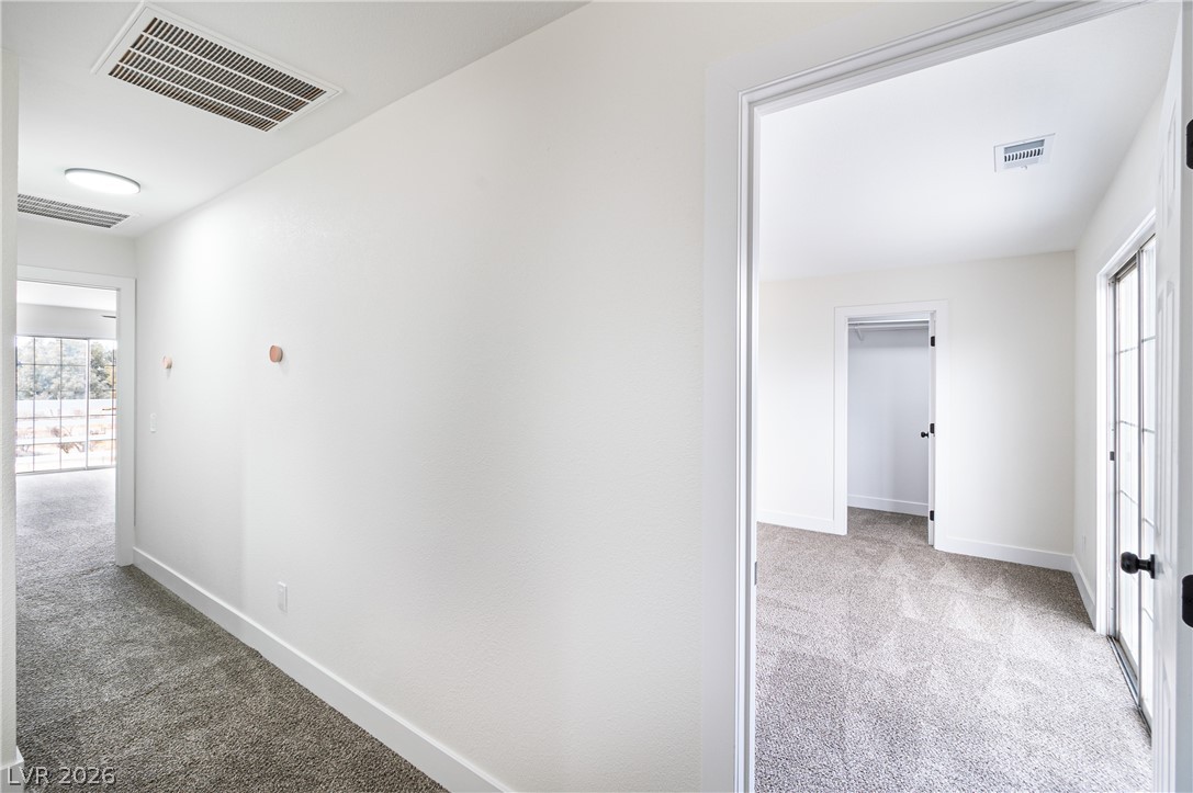 1891 Brian Road Pahrump, NV 89048 - Photo 27 of 50 Hall with visible vents, baseboards, and carpet