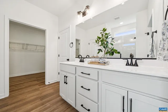 a bathroom with a double vanity sink and a mirror