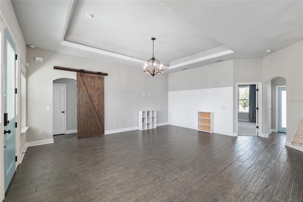 2556 Southwest 118th Terrace Gainesville, FL 32608 - Photo 11 of 72 a view of an empty room with wooden floor