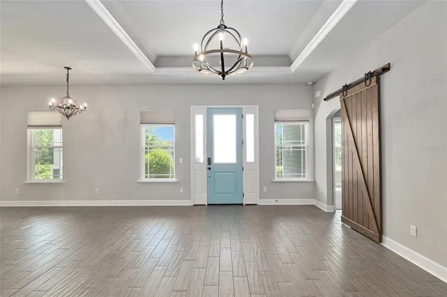 a kitchen with kitchen island a counter top space stainless steel appliances and a window