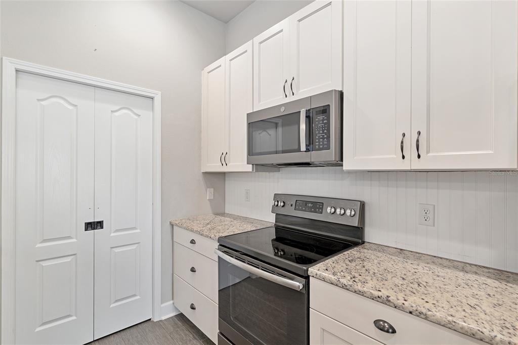 2556 Southwest 118th Terrace Gainesville, FL 32608 - Photo 20 of 72 a kitchen with white cabinets and appliances