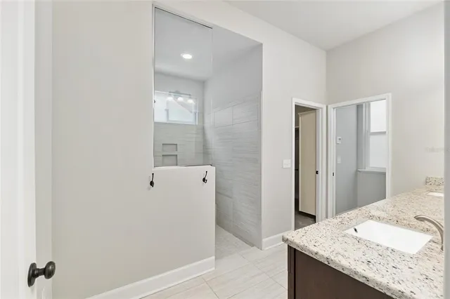 an empty room with chandelier fan