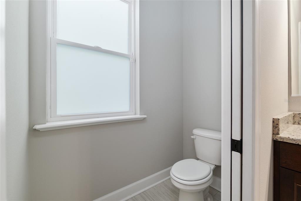 2556 Southwest 118th Terrace Gainesville, FL 32608 - Photo 37 of 72 a white toilet sitting next to a bathroom sink