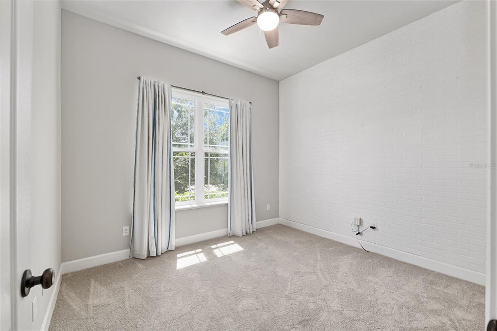 2556 Southwest 118th Terrace Gainesville, FL 32608 - Photo 39 of 72 an empty room with chandelier fan
