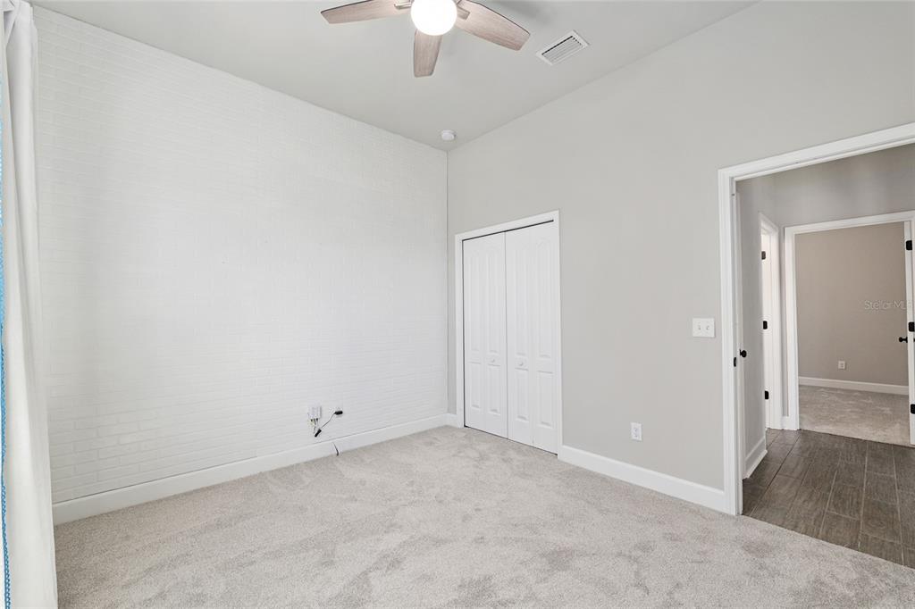 2556 Southwest 118th Terrace Gainesville, FL 32608 - Photo 40 of 72 an empty room with a ceiling fan and a window