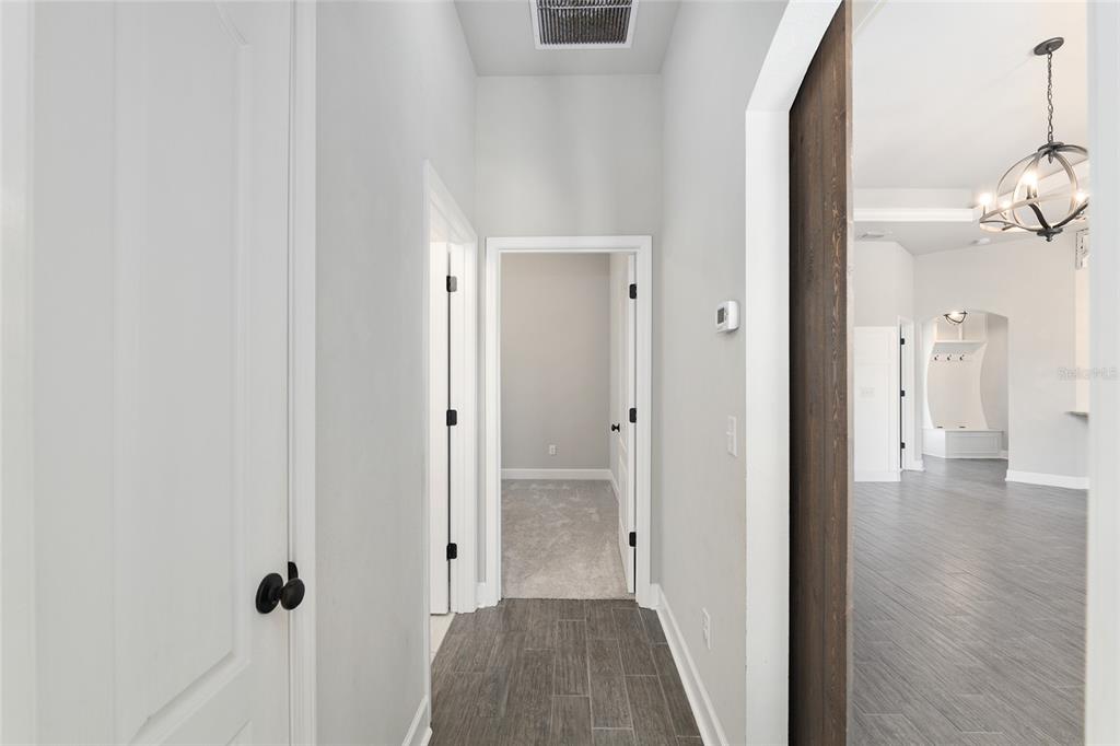 2556 Southwest 118th Terrace Gainesville, FL 32608 - Photo 41 of 72 a view of a hallway with wooden floor and staircase