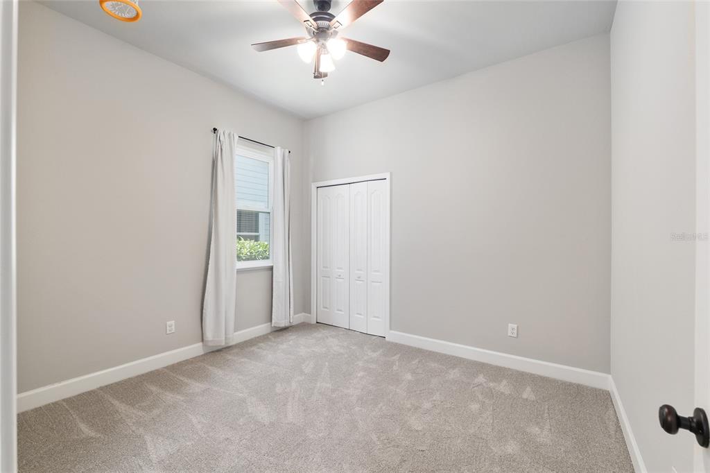 2556 Southwest 118th Terrace Gainesville, FL 32608 - Photo 44 of 72 an empty room with a ceiling fan and a window