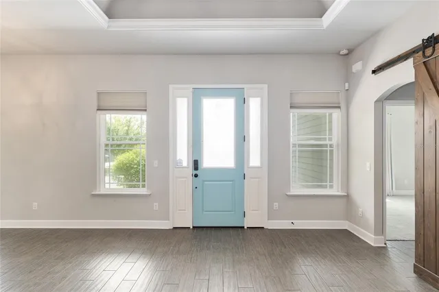 a view of an empty room with wooden floor