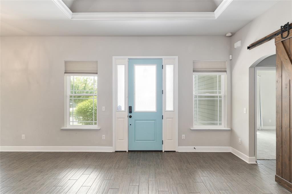 2556 Southwest 118th Terrace Gainesville, FL 32608 - Photo 9 of 72 an empty room with wooden floor and windows