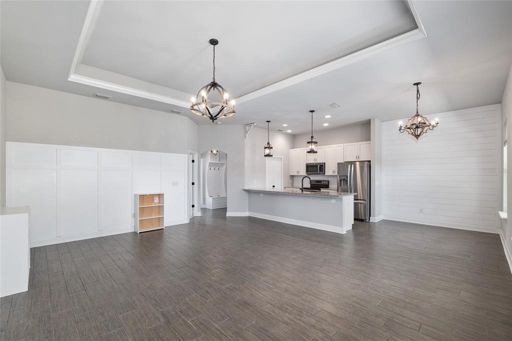 2556 Southwest 118th Terrace Gainesville, FL 32608 - Photo 10 of 72 a view of a livingroom with a kitchen and a stove wooden floor kitchen view