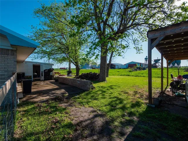 a view of a backyard with sitting area