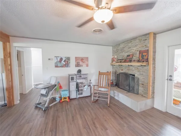 a view of a livingroom with furniture and a fireplace