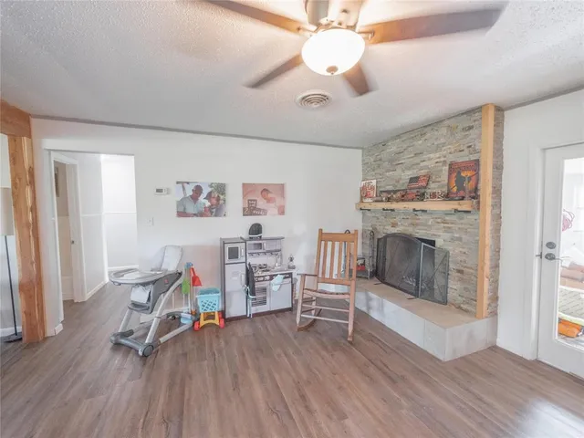 a view of a livingroom with furniture and a fireplace