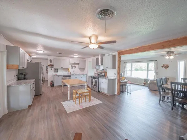 a living room with furniture and kitchen view
