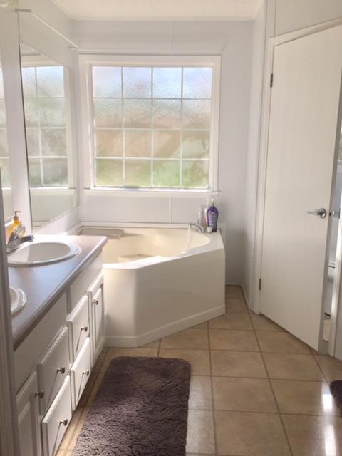 277 Autumn Road Morrison, TN 37357 - Photo 8 of 17 a bathroom with a tub sink and window