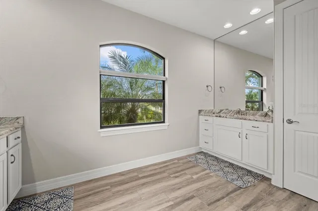 a bedroom with a bed dresser and a window