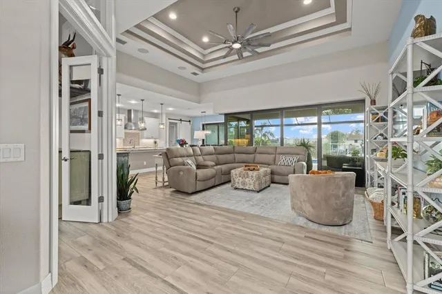 a living room with furniture and a floor to ceiling window
