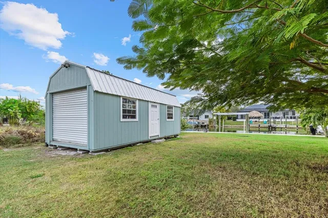 an aerial view of a house with a yard and large trees