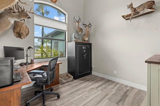 a view of a workspace with furniture and a window