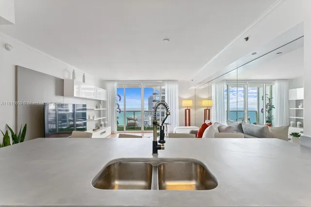 a kitchen with kitchen island a sink and a large window