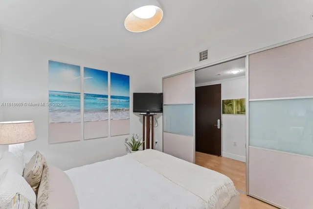 a bedroom with a bed and a television